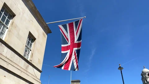 Union Jack flag waving outside the Royal Horse Guards in London on a sunny day Stock Footage 318214069