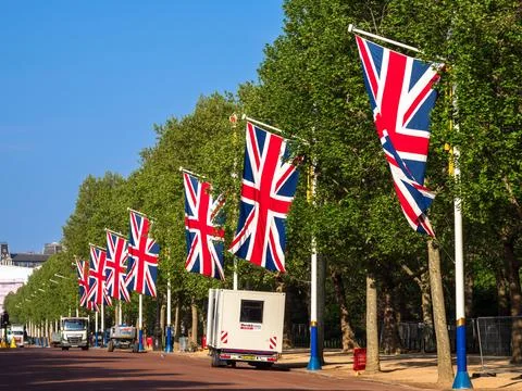 Union Jack Flags Lining a Tree-Lined Street Stock Photos
