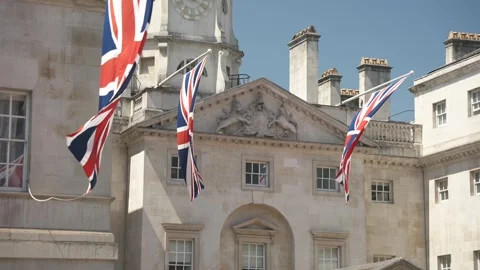 Union Jack flags, tourists and horse guard at Dover House, London, England Stock Footage 243036877