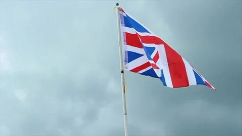 Union Jack flys in cloudy sky Stock Footage 112017854