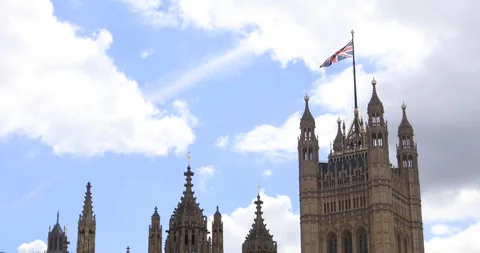 Union Jack over Westminster Palace spires in London sky Stock Footage 319793084