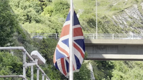 Union Jack waving against bridge 4K Stock Footage 336505546