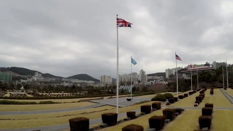 Union Jack Waving in the air of UN cemetary Stock Footage 104267637