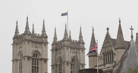 Union Jack waving in front of gothic cathedral spires in London. Stock Footage 319792596