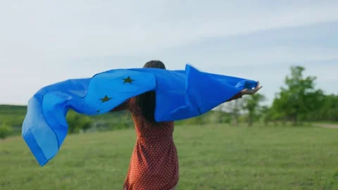 Union in Motion Young Woman's Back View Running with EU Flag Stock Footage 274703418