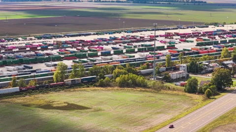 Union Pacific Intermodal Terminal Beside Highway and Farmland Stock Footage 337512743