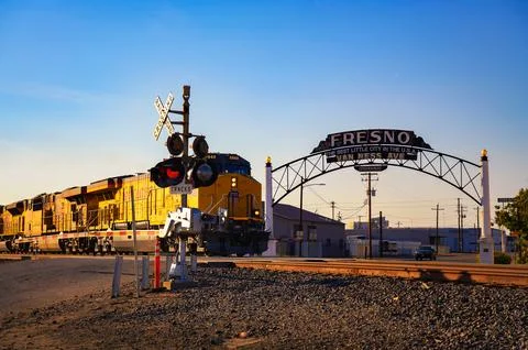 Union Pacific train passing through Fresno, California at sunset Фото