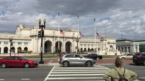 Union Station Washington D.C. flags flow at half mast with traffic train station Stock Footage 61863799