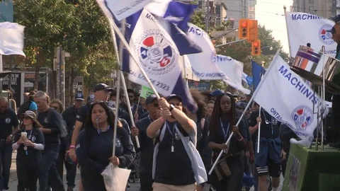Union workers marching in solidarity for good job in Toronto labor day parade Stock Footage 79687914