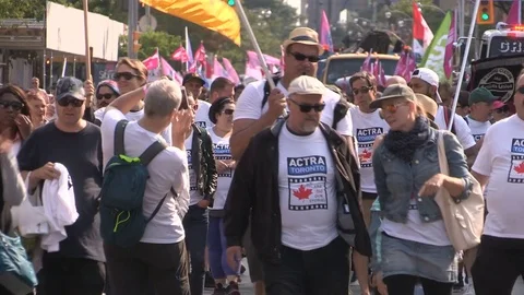 Union workers marching in solidarity for good job in Toronto labor day parade Stock Footage 79692054