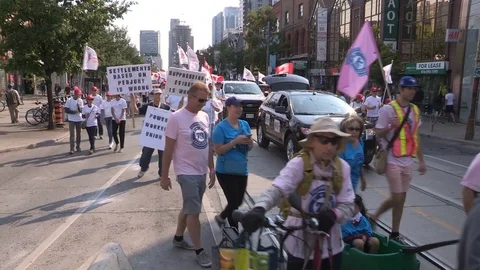 Union workers marching in solidarity for good job in Toronto labor day parade Stock Footage 79692585