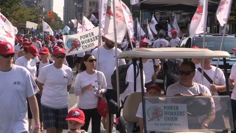 Union workers marching in solidarity for good job in Toronto labor day parade Stock Footage 79692664