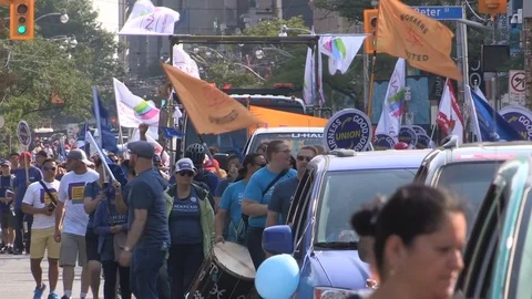 Union workers marching in solidarity for good job in Toronto labor day parade Stock Footage 79694670
