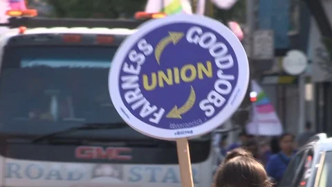 Union workers marching in solidarity for good job in Toronto labor day parade Stock Footage 79695028