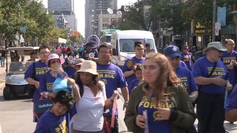 Union workers marching in solidarity for good job in Toronto labor day parade Stock Footage 79695286