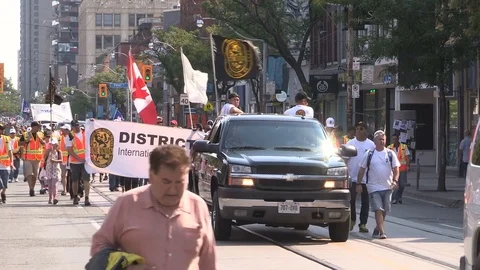 Union workers marching in solidarity for good job in Toronto labor day parade Stock Footage 79697047