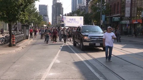 Union workers marching in solidarity for good job in Toronto labor day parade Stock Footage 79697237