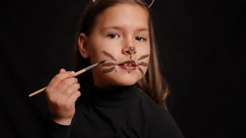 A Unique and Creative Cat Makeup Transformation Featuring Stylish Black Attire Stock Footage 315413872