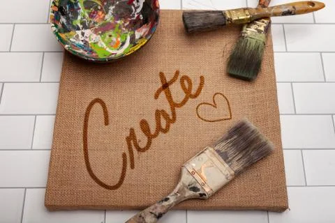 Unique background the Word Create on brown burlap canvas Stock Photos