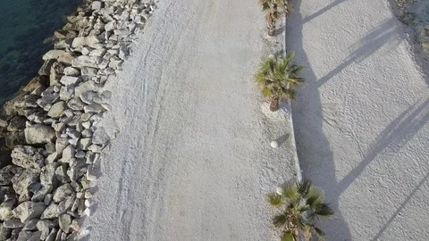 Unique Backwards Moving and Lifting Drone Shot of Small Beach Peninsula 動画素材 90637532