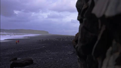 Unique basalt columns attract tourists at Reynisfjara Beach in Iceland Stock Footage 329442722