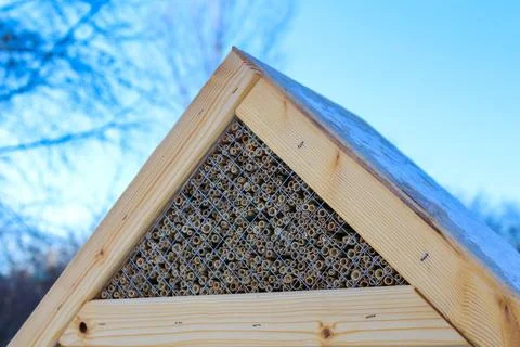 Unique bee hotel structure with natural materials in a serene environment Stock Photos