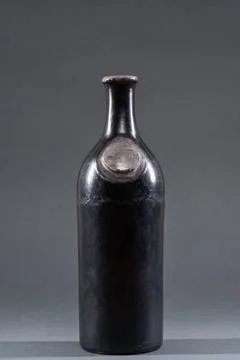 Unique black ceramic bottle with a round neck and smooth surface displayed .. Stock Photos