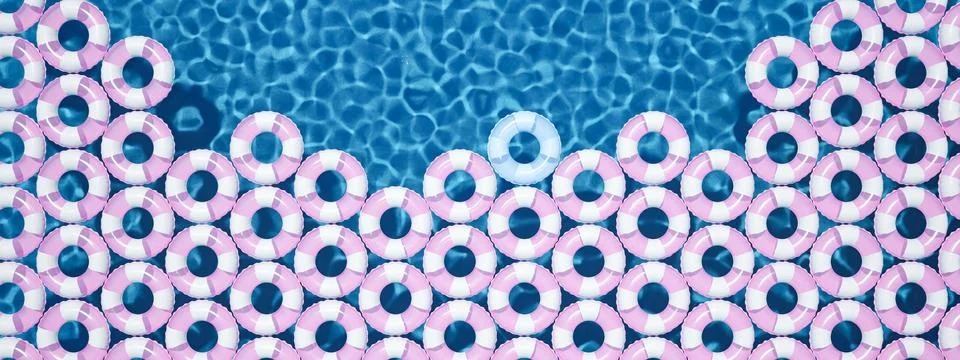 Unique blue float ring between pink float rings in pool. 3d rendering Illustrazione stock