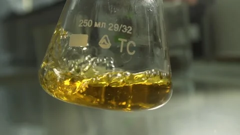Unique chemical liquid being mixed inside a medical flask. Stock Footage 132963007
