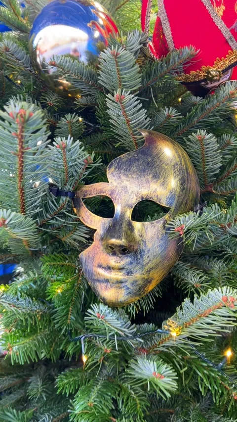 Unique Christmas tree with masks and ornaments in urban setting Stock Footage 324077231