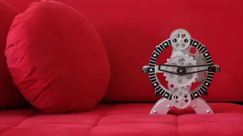 Unique clock design on a vibrant red couch Video stock 320391903