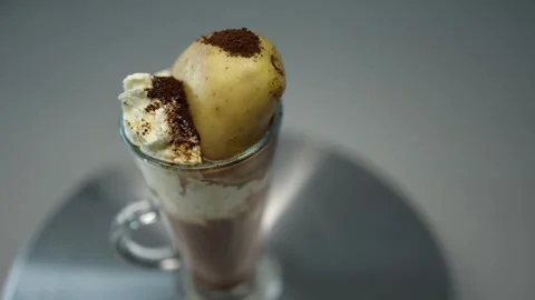 A unique coffee dessert featuring a tall glass of creamy affogato with vanilla i Stock Footage 300021825