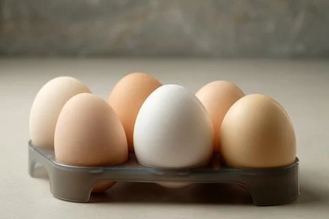 Unique collection of eggs on a gray surface for culinary inspiration Foto stock