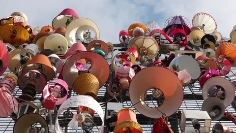 Unique collection of lamps displayed on a wall in an urban area Video stock 345055991
