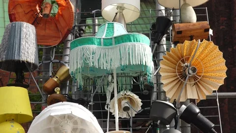 Unique collection of lamps displayed on a wall in an urban area Video stock 345055992