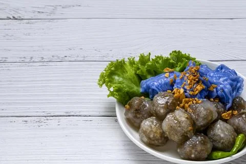 Unique culinary dish featuring blue dessert and savory meatballs Stock Photos