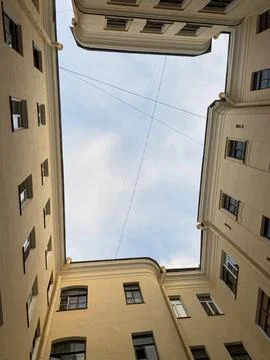 A unique, dramatic low-angle shot looking straight up into a rectangle of sky fr Stock Photos