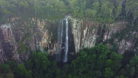 Unique drone view through suspended mist revealing a majestic waterfall spilling Video stock 294635778