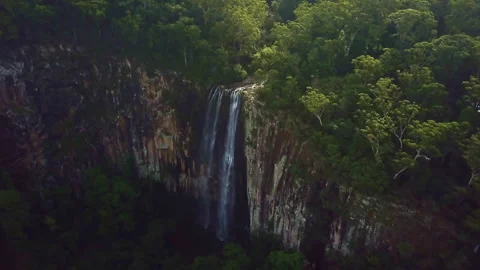 Unique drone view through suspended mist revealing a majestic waterfall spilling Video stock 294635875