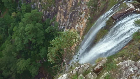 Unique drone view through suspended mist revealing a majestic waterfall spilling Video stock 294636067