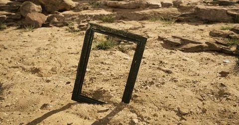 Unique empty frame stands in the sandy desert landscape under bright sunlight Stock Illustration