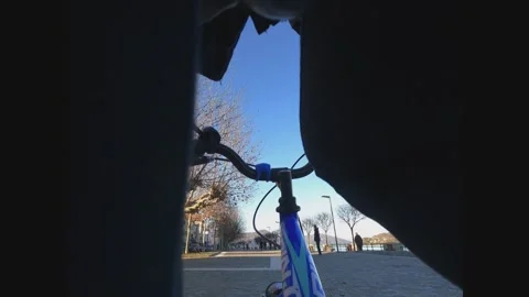 Unique first-person pov through kid’s legs while riding bicycle Stock Footage 278947566