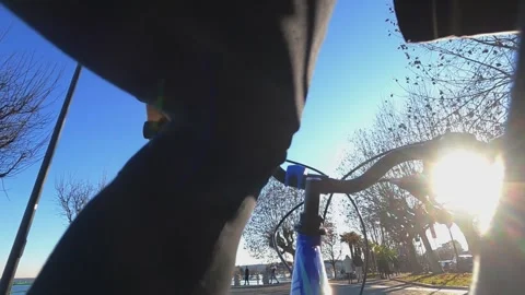 Unique first-person pov through legs of kid riding bicycle Видео 279848024
