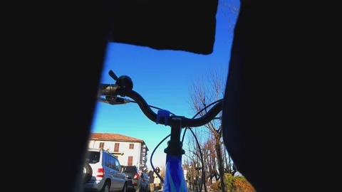 Unique first-person pov through legs of kid riding bicycle Stock Footage 280883709