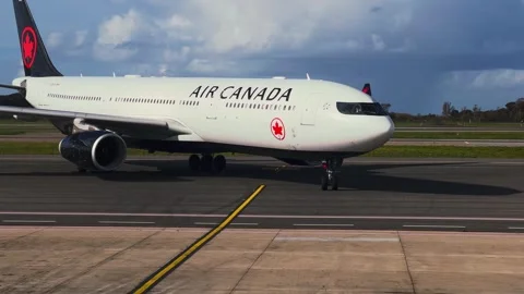 Unique frontal view of air canada airplane taxiing to terminal gate Stock Footage 284453977