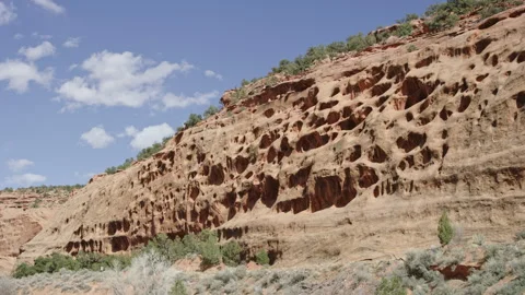 Unique geological feature, Escalante red rock cliffside holes from erosion Stock Footage 248582825