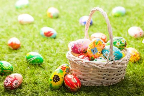Unique hand painted Easter eggs in basket on grass Stock-Fotos