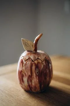 Unique handmade ceramic trinket box in the shape of an elongated apple with a Stock Photos