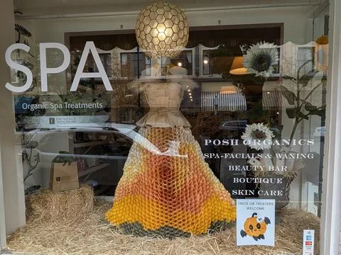 Unique handmade store display featuring a golden honeycomb-style dress Stock Photos