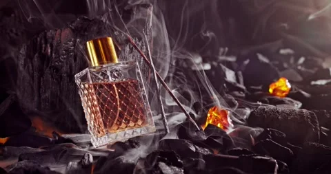 Unique incense perfume in translucent glass bottle on coal. Stock Footage 331309640